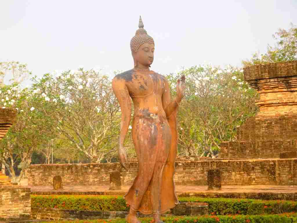 Walking Buddha at the Sukhothai Historical Park in Thailand