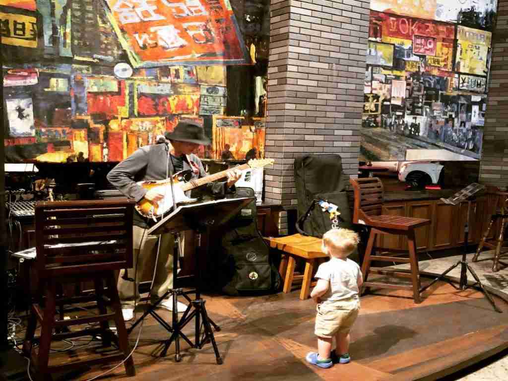 A little boy dancing to live music in Chinatown Bangkok, Thailand