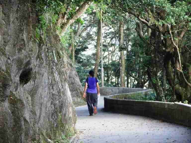 woman walking on a winding path on the peak, one of the top attractions in Hong Kong