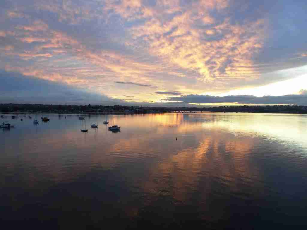 stunning sky colours reflected in the still water at Captain Cook Bridge San Souci