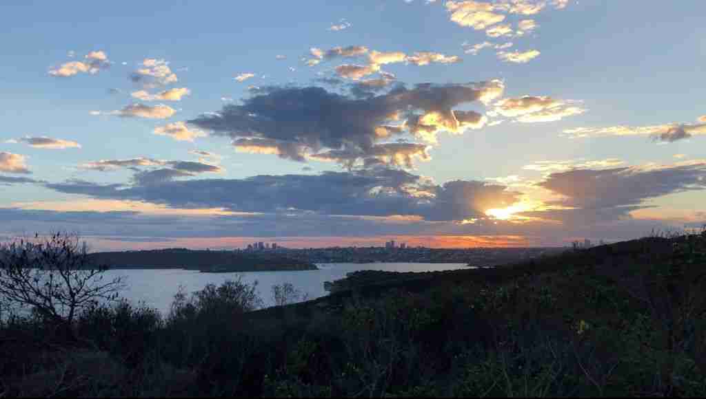 distant city views at sunset at Fairfax Lookout in Manly