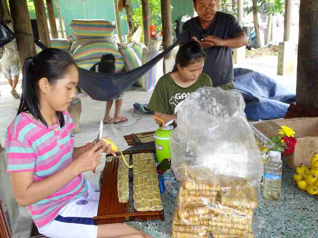 girls cutting up bananas in Battambang Cambodia