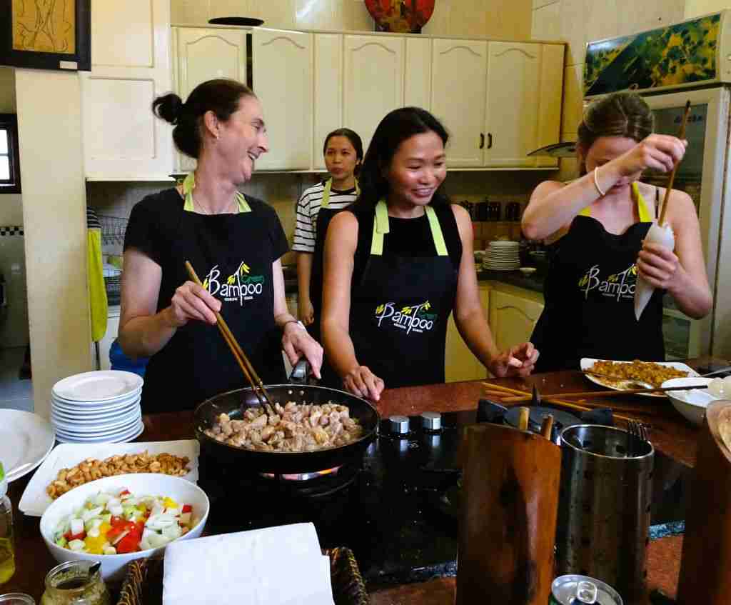 having fun cooking with chopsticks at a Green Bamboo Cooking Class with Van in Hoi An