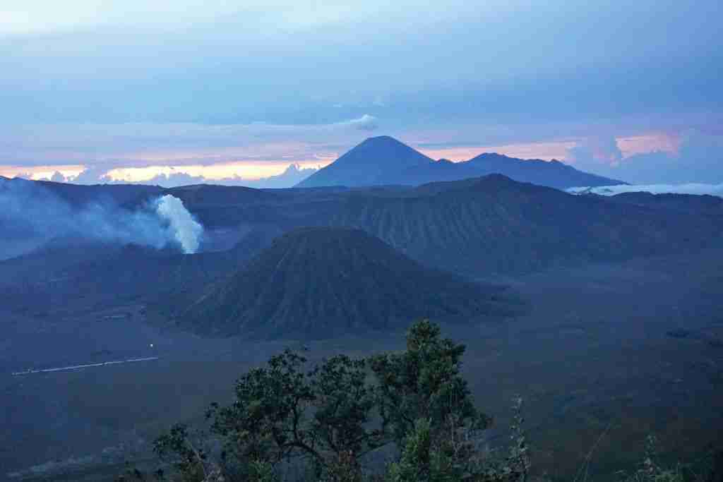 the sun sising behind Mount Bromo in Indonesia