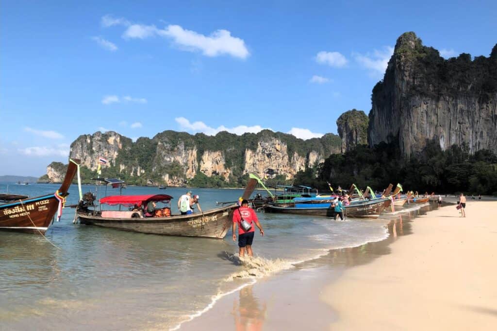 Ao Nang or Railay Beach with colourful Long tail boats moored at the beach