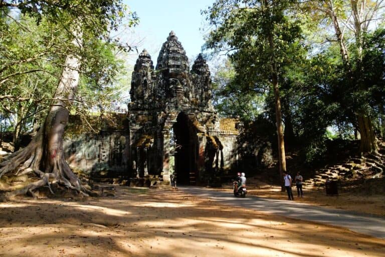 The ancient stone ruins of Angkor Wat surrounded by jungle