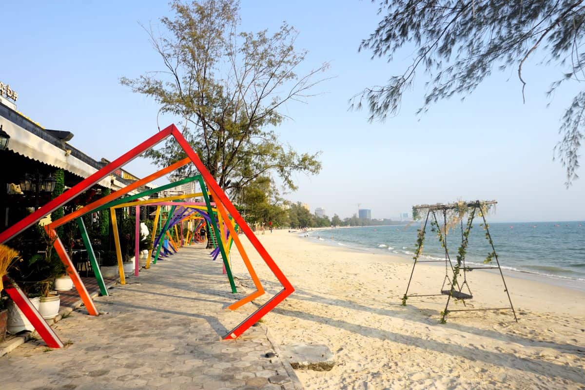 beach with golden sands. blue water and apathway with red border