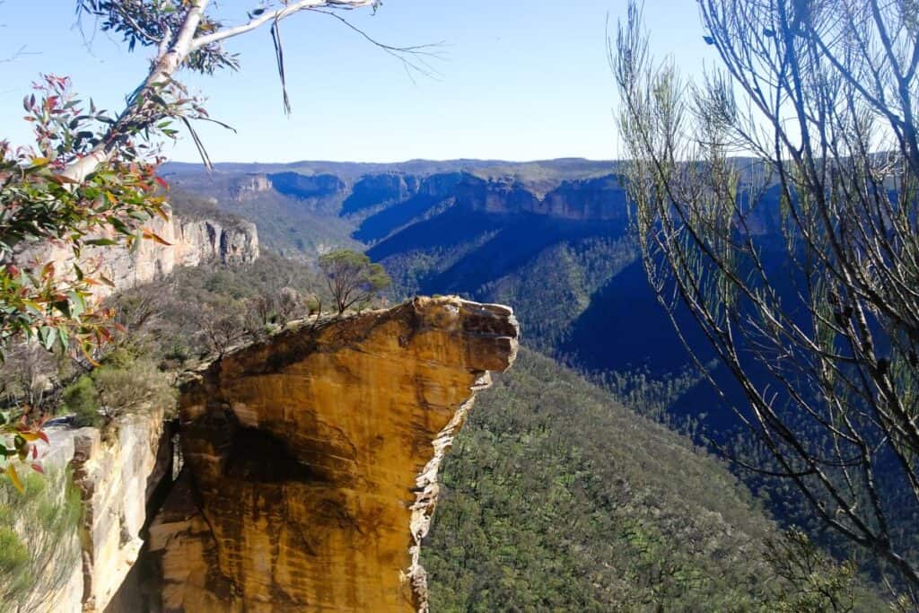 an outcrop of golden sandstone jutting out into the valley at Hanging Rock Blackheath