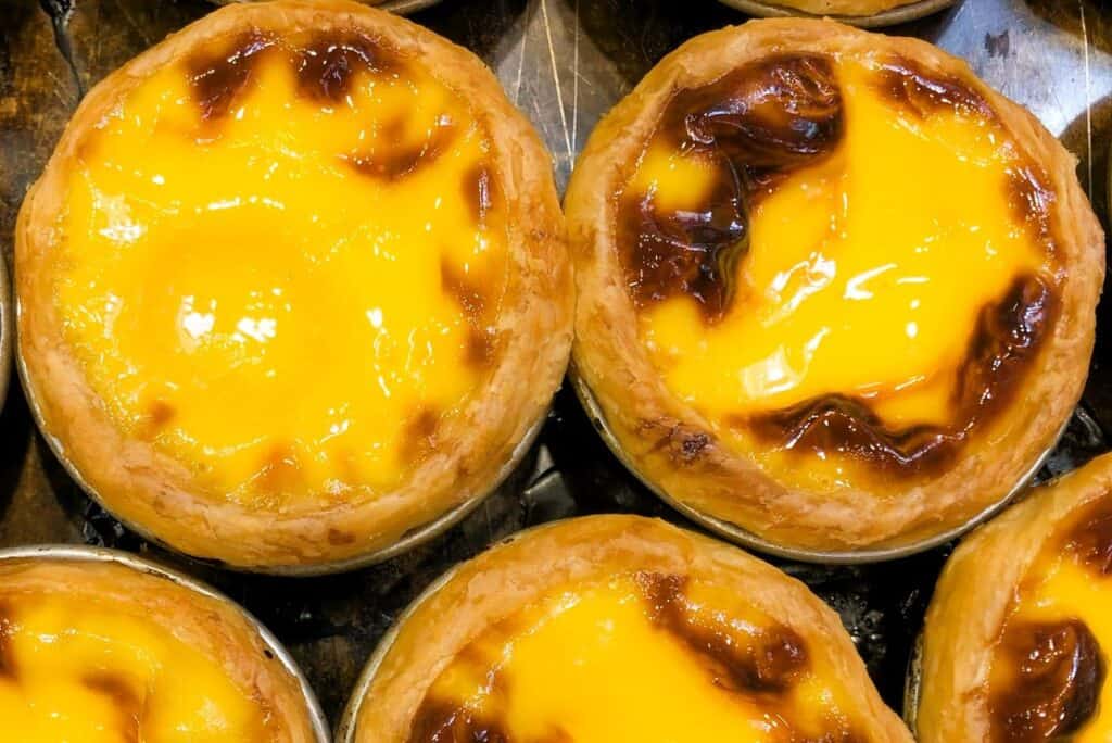 Yellow Portuguese custard tarts with crispy puff pastry
