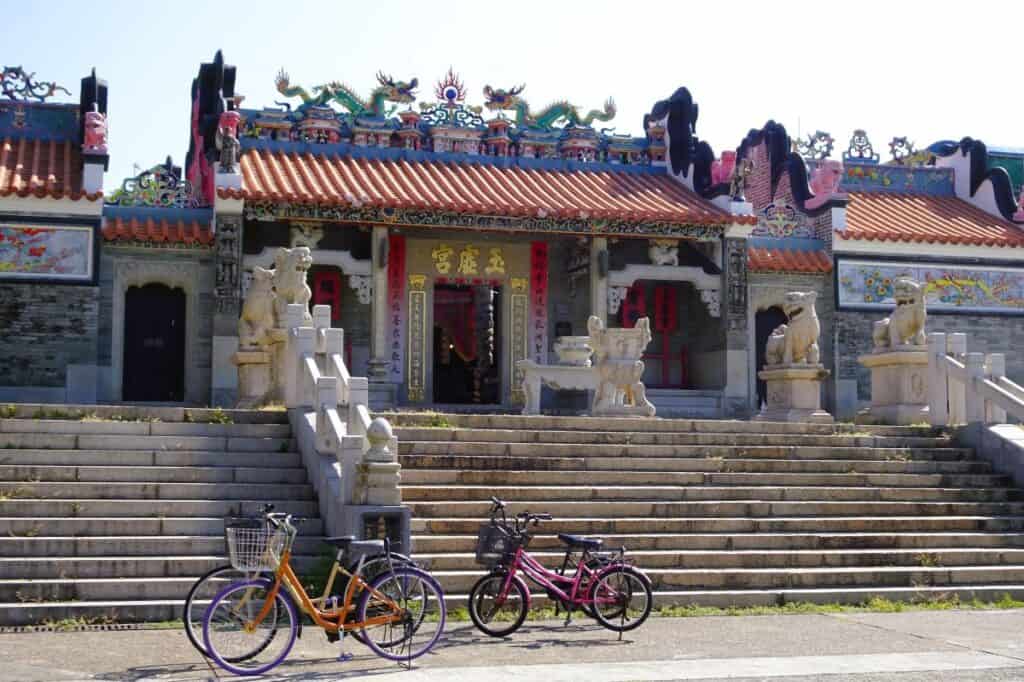 A colourful Taoist Temple with bicycles out the front on Cheung Chau Hong Kong