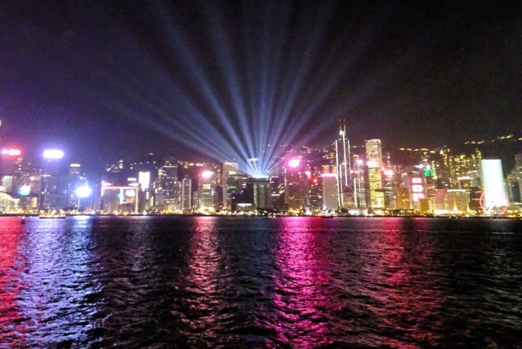 Laser show and colourful lights at night on Victoria Harbour Hong Kong