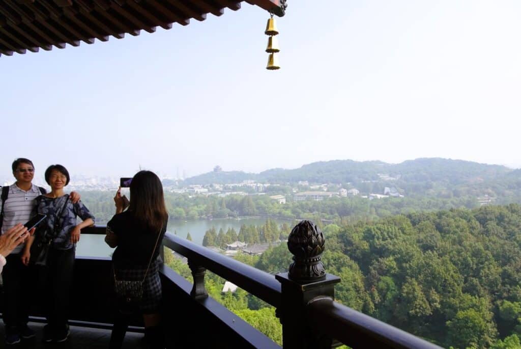 a family taking photos at the top of the Leifeng Pagoda Westlake China