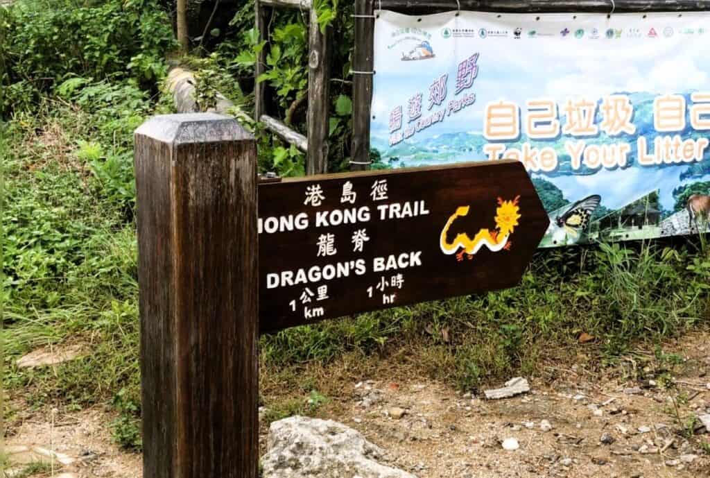 brown sign post at the start of the Dragons back hike Hong Kong