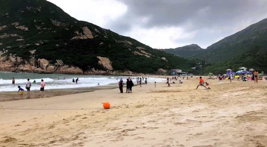 Golden sands at surf with families playing at Big Wave Beach Hong Kong
