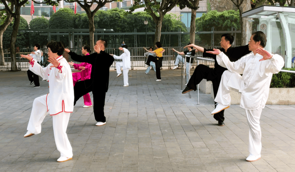 Chiese people practising Tai Chi wearing white silk pajamas