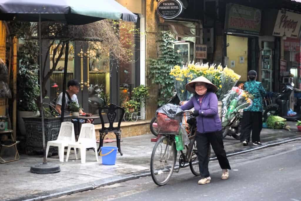 Flower seller with a bicycle in Hanoi Vietnam
