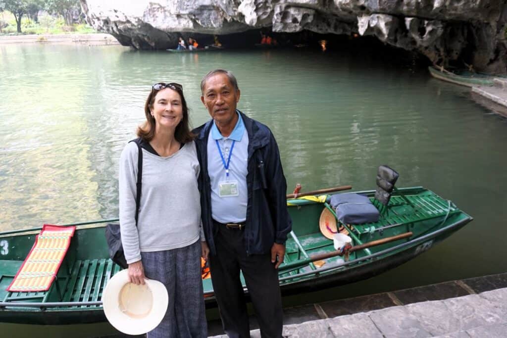 posing for a photo with my boatman by the river in Tam Coc Vietnam