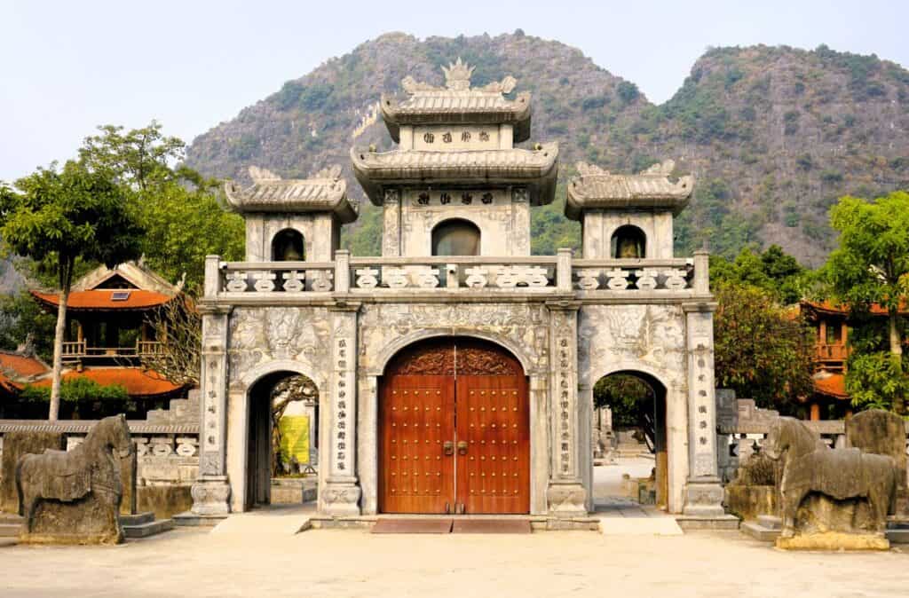 grand stone entrance to the Thai Vi Temple in Tam Coc