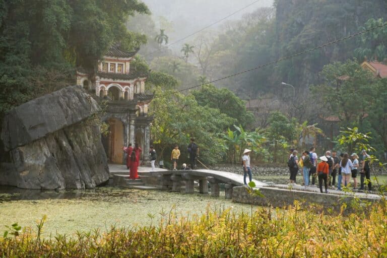Ninh Binh Travel guide Bridge over a lake to the Bich Dong Pagoda at the foot of a mountain