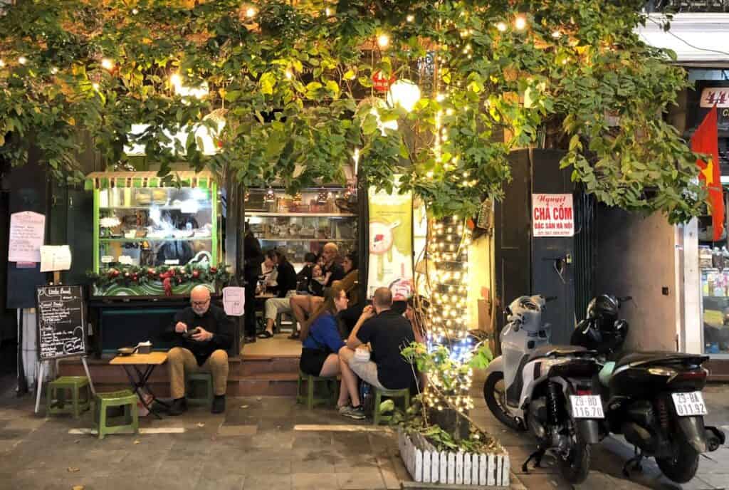 small restaurants with people sitting at  outside tables