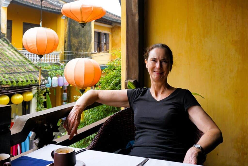 relaxing on the balcony  with a coffee overlooking orange lanterns 