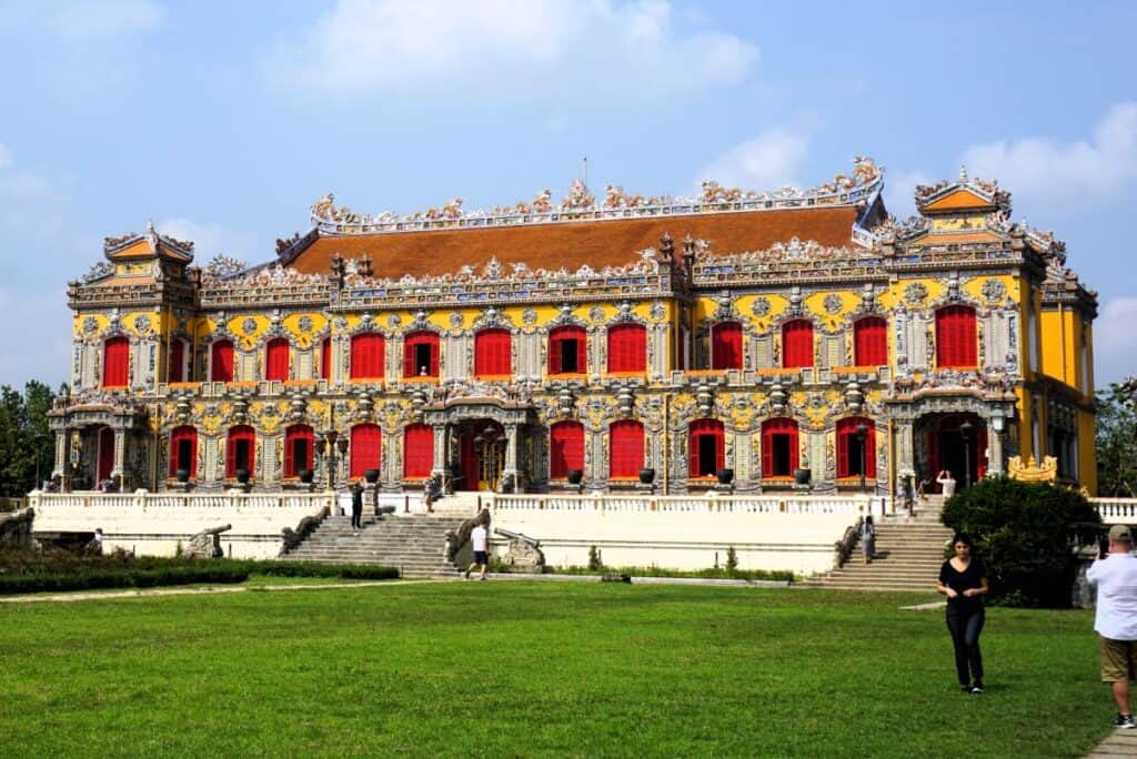 Ornate Vietnamese palace with red windows and yellow trimmings
